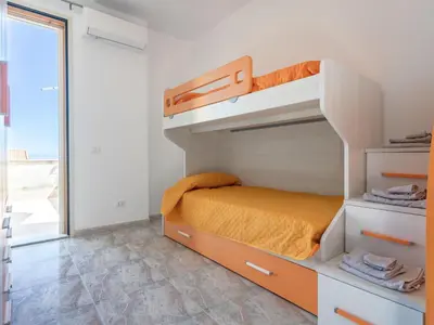 a small bedroom with a bunk bed and a window at Holiday Home Alice by Interhome in Ficarazzi