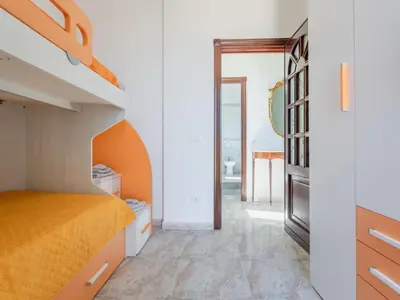 a bedroom with an orange bed and a hallway at Holiday Home Alice by Interhome in Ficarazzi
