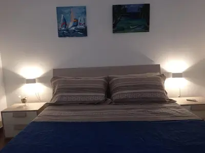 a bedroom with a bed with two lamps on both sides at Al Molo 6 in Palermo