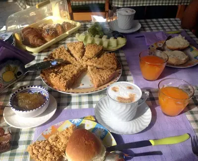 a table with plates of food on a table at B&B Poliglotta in Castelluzzo