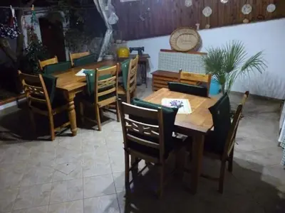a dining room with a wooden table and chairs at B&B Poliglotta in Castelluzzo