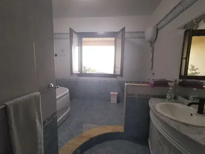 a bathroom with a sink and a tub and a window at B&B La Fenice in Termini Imerese