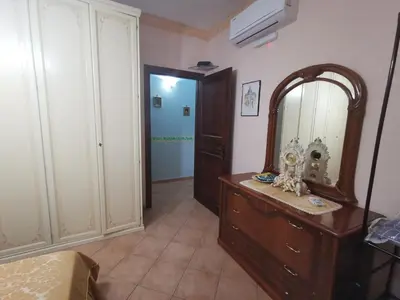 a bathroom with a dresser and a mirror in a room at B&B La Fenice in Termini Imerese