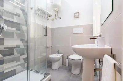 a bathroom with a sink and a toilet and a shower at GuestHost - Stazione Notarbartolo Bright & Cozy Apartment in Palermo