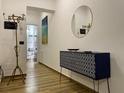 a room with a mirror and a table and a tripod at BB4U Apartments al Massimo in Palermo