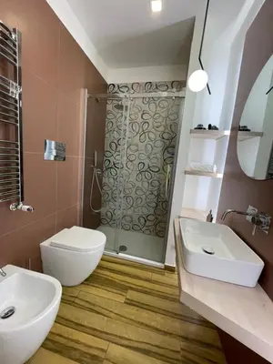 a bathroom with a shower and a toilet and a sink at BB4U Apartments al Massimo in Palermo