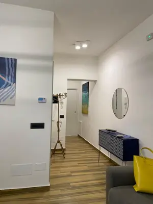 a living room with a couch and a mirror at BB4U Apartments al Massimo in Palermo