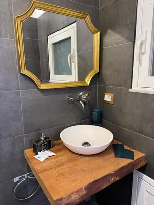 a bathroom with a sink and a mirror on a counter at CapoCathedral apartment in Palermo
