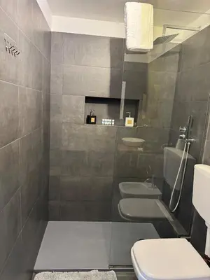a bathroom with three sinks and a toilet at CapoCathedral apartment in Palermo