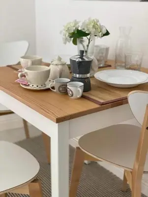 a table with plates and cups and a vase with flowers at CapoCathedral apartment in Palermo