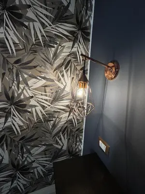 a room with a table and a lamp and a wall at CapoCathedral apartment in Palermo