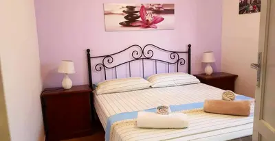a bedroom with a large bed with two night stands at Charming house with sea and mountain views in Alcamo in Alcamo