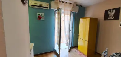 a room with a yellow refrigerator and a green wall at Charming house with sea and mountain views in Alcamo in Alcamo