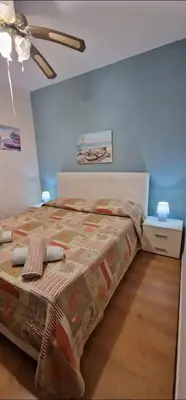 a bedroom with a bed and a ceiling at Charming house with sea and mountain views in Alcamo in Alcamo