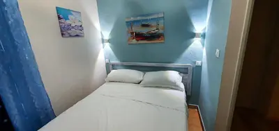 a small bed in a room with two pillows on it at Charming house with sea and mountain views in Alcamo in Alcamo
