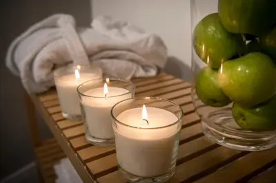 four candles on a wooden table with green apples at Residence Torremuzza - Charming House In The Heart Of Palermo with lovely view in Palermo