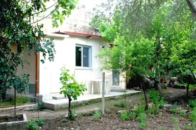 a white house with trees in front of it at Camera indipendente con bagno immersa nel verde in Bagheria