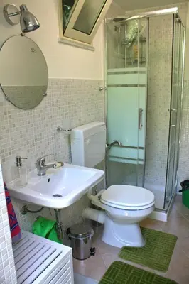 a bathroom with a toilet and a sink and a shower at Camera indipendente con bagno immersa nel verde in Bagheria