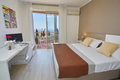 a bedroom with a bed and a desk with a computer at Hotel Bel 3 in Palermo