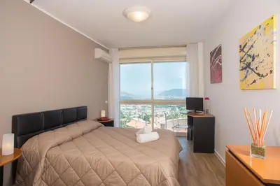 a bedroom with a bed and a large window at Hotel Bel 3 in Palermo