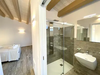a bathroom with a glass shower and a sink at L'Ulivo Comfort Rooms in Terrasini