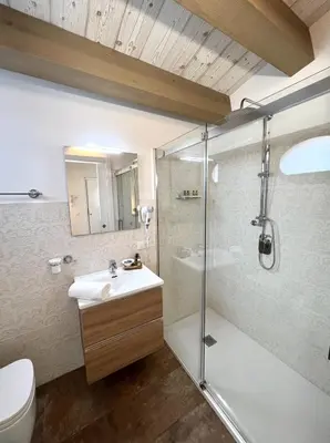 a bathroom with a shower and a sink and a toilet at L'Ulivo Comfort Rooms in Terrasini