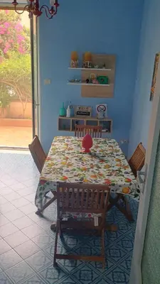 a dining room table with chairs and a table with at La casetta della Letizia in Mondello