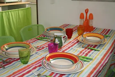 a table with plates and utensils on a striped table cloth at La casa sull'albero in Palermo