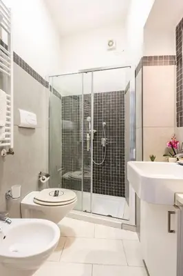 a bathroom with a shower and a toilet and a sink at La Boucherie in Palermo