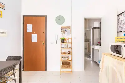 a room with a door and a kitchen with a table at La Boucherie in Palermo