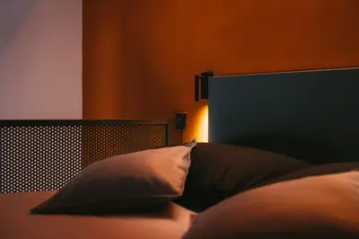 a bed with two pillows and a head board at MONTESANTO36 APARTMENTS in Palermo