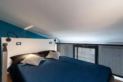 a bedroom with a blue bed and a window at MONTESANTO36 APARTMENTS in Palermo
