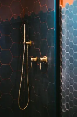 a shower in a bathroom with a tile wall at MONTESANTO36 APARTMENTS in Palermo