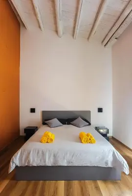 a bedroom with a large bed with yellow pillows at MONTESANTO36 APARTMENTS in Palermo