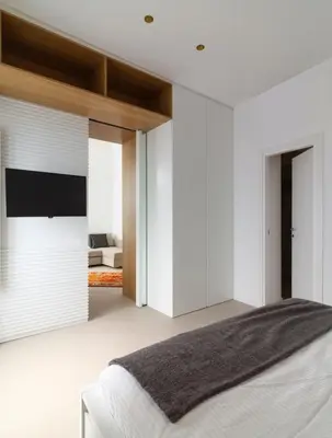 a bedroom with white walls and a large bed at La casetta in centro storico: Pantelleria 9 in Palermo