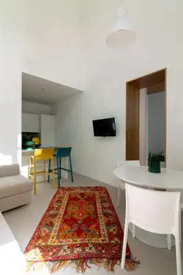 a living room with a table and a rug at La casetta in centro storico: Pantelleria 9 in Palermo