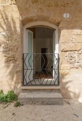 a window with a iron railing in a building at La casetta in centro storico: Pantelleria 9 in Palermo