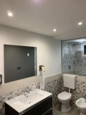 a bathroom with a sink and a toilet and a mirror at Loft Nataly in Palermo