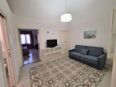 a living room with a couch and a tv at Casa Lara in Castellammare del Golfo
