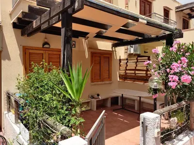 a patio with a bench and a wooden pergola at Makari mare in Macari
