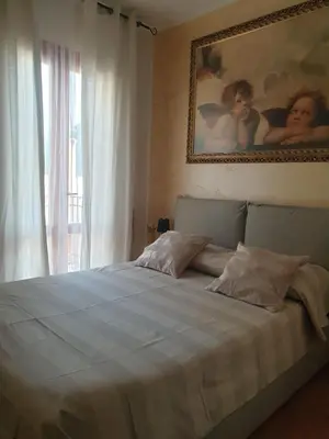 a bedroom with a bed with a painting on the wall at Makari mare in Macari
