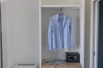 a white jacket is hanging in a closet at B&b Villa Cusenza in Partinico