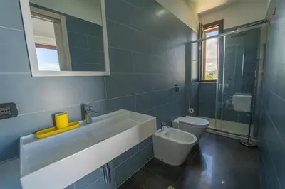 a bathroom with a sink and a toilet at B&b Villa Cusenza in Partinico