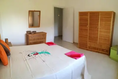a bedroom with a bed and a dresser and a mirror at Villa Bouganville - charming sea ​​view- 160 mq in Alcamo