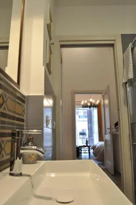a bathroom with a white sink and a mirror at Binario 91 Rooms in Palermo