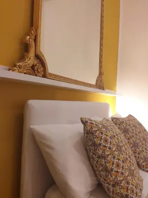 a bedroom with two beds and a chandelier at Binario 91 Rooms in Palermo