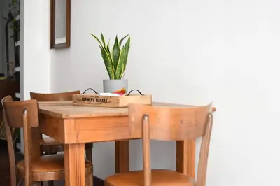 a wooden table with chairs and a plant on it at iFlat Key House tra il centro e il mare in Palermo