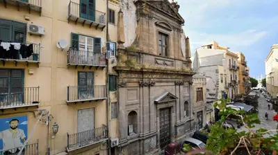 an old building with windows and balconies on a street at iFlat Key House tra il centro e il mare in Palermo