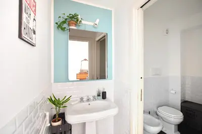 a bathroom with a sink and a toilet and a mirror at iFlat Key House tra il centro e il mare in Palermo