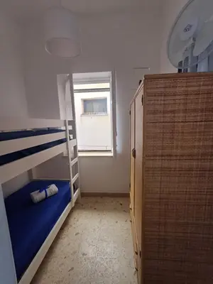 a small room with a bunk bed and a window at Le due conchiglie in Carini